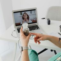 A medical professional consulting a patient online via video call for remote healthcare services.